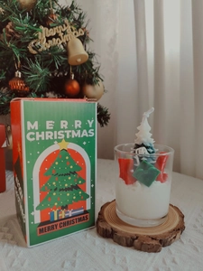 Detail of Christmas strawberry chocolate candle with festive tree and gift box