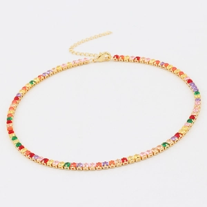 Detailed shot of golden necklace featuring vibrant square-cut colorful zircons and lobster clasp