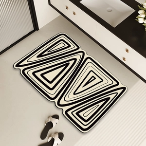 Irregular black and white geometric bath mat with anti-slip absorbent surface