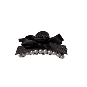 Elegant French black satin bow hair clip decorated with white pearls on a white background