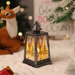 Detail of vintage Christmas lantern with reindeer motif and warm LED candle light