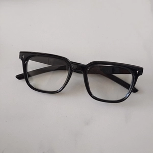 Detail view of black square kids sunglasses with decorative star-shaped metal rivets