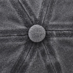 Macro shot of gray cotton baseball cap top showing detailed stitching and fabric texture