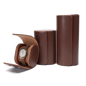 Detailed macro view of brown leather watch rolls with soft velvet lining and snap closures