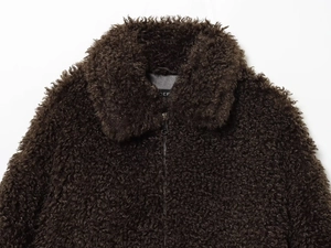 Detailed close-up of a brown fuzzy fleece jacket featuring a black zipper and stand collar