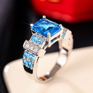 Macro detail of luxury square blue gemstone ring with four-prong silver metal setting