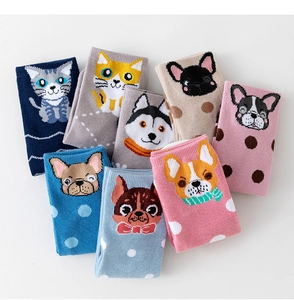 Close-up of colorful cartoon animal crew socks in various colors with cute dog and cat patterns