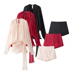 Flat lay of pleated puff sleeve tops and shorts set in beige, red and black colors