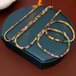 Detailed set of gold plated necklaces and bracelet with vibrant multi-colored gemstones