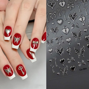 Detail of silver 3D metallic nail stickers with butterfly and gothic heart patterns