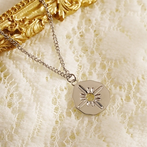 Vintage irregular sunburst star pendant necklace in silver finish on lace background