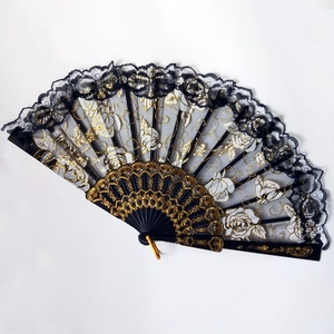 Detail of black lace folding fan featuring gold rose embroidery and ornate carved ribs