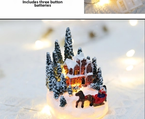 Detail of a Christmas resin house ornament with warm LED lighting and miniature snow sled