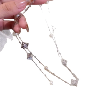 Elegant silver necklace with white pearls and vintage-style diamond floral pendants