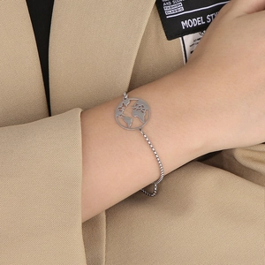 Detail of silver hollow world map charm on a stainless steel adjustable box chain bracelet