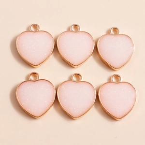 Pack of heart shaped gold charms with pink glitter enamel for DIY jewelry making