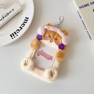 Plush brown bear photo card holder with pink earmuffs and a transparent window display