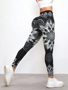 Detail of high waist yoga leggings featuring intricate black and white mandala print texture