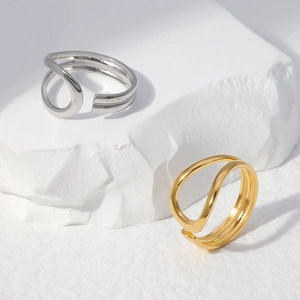 Minimalist double layer open rings in gold and silver finish on stone display base