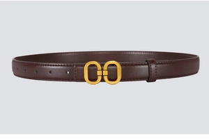 Detail of slim dark brown leather belt with matte gold double oval buckle and fine stitching