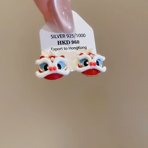 Detail of red enamel lion dance stud earrings with pearl and white faux fur accents