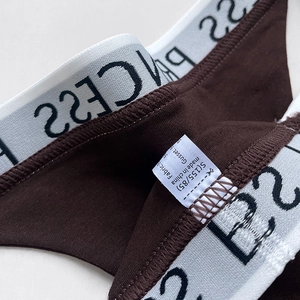 Brown cotton athletic thong with white PRINCESS logo elastic waistband and soft knit texture