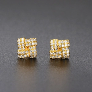 Close-up of gold-plated square stud earrings with micro-pave cubic zirconia stones