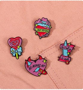 Detail of pink enamel pins set including love potion bottle and dagger with slogan