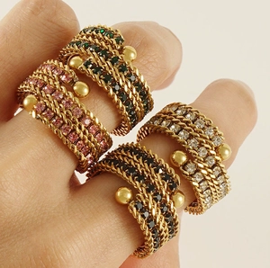 Macro shot of 18k gold plated multi-layer braided rings with colorful zircon inlay