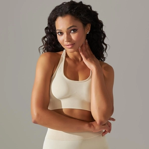 Close-up of seamless knit sports bra featuring ribbed hem and racerback detail in beige