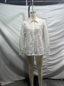 Detail of white lace hollow-out embroidery and turn-down collar on long sleeve shirt