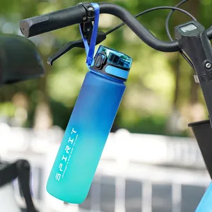 Blue-green gradient 32oz 1L sports water bottle hanging on a bicycle during outdoor cycling