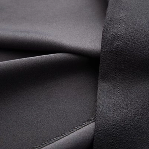Macro texture of charcoal grey fabric showing premium knit structure and material depth