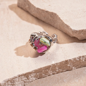 Detail of silver irregular ring with pink, green and amber crystals on raw stone