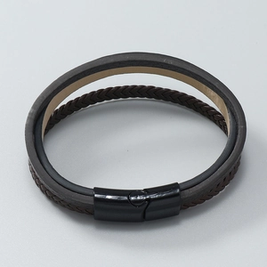 Macro shot of double-layer braided leather bracelet with black magnetic metal clasp