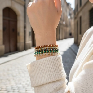Detail of 4mm faceted Amazonite and semi-precious stone bead bracelets on a model's wrist
