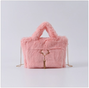 Detail of pink faux rabbit fur bag featuring a golden antler buckle and metal tassels