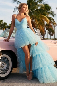 Detail of light blue tulle gown with silver star sequins by a vintage pink car