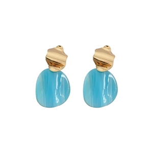 Irregular acrylic oval earrings with gold metal top and translucent blue pendants