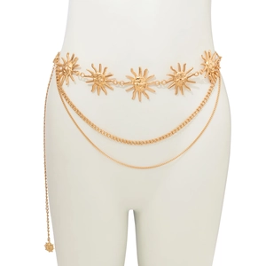 Detailed view of bohemian gold sun medallion waist chain with layered tassels on model