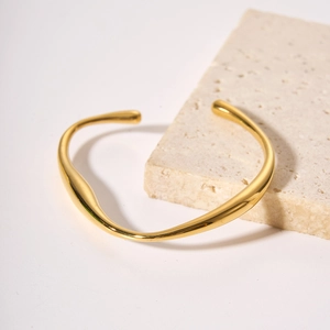 Irregular streamlined golden open cuff bracelet in minimalist stainless steel for women
