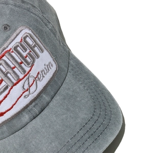 Close-up of vintage washed denim baseball cap featuring America embroidery and stitching