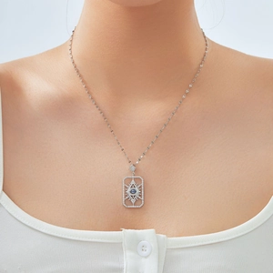 Silver geometric evil eye pendant necklace with blue zircon inlay on female model