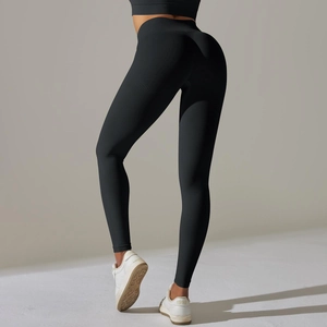 Detailed close-up of seamless black high-waisted yoga pants with body-shaping texture