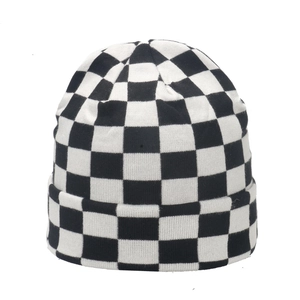 Classic black and white checkered knit beanie hat for women in a minimalist winter style