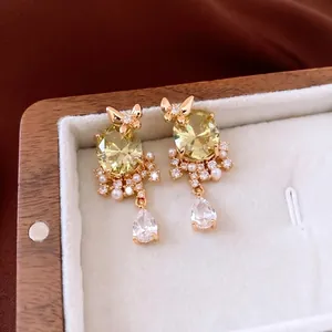 18k gold plated butterfly drop earrings with yellow zircon and white pearl accents