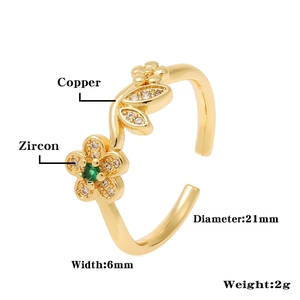 Detail of adjustable golden copper flower ring with green zircon and pavé crystals