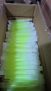 Top view of bright green glow sticks packed neatly in a box for rescue or parties