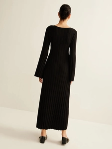 Elegant slim fit black knit dress with long flared sleeves and a back-view silhouette