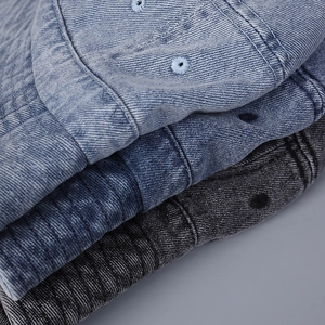 Macro detail of washed denim bucket hats in light blue, medium blue and dark grey tones